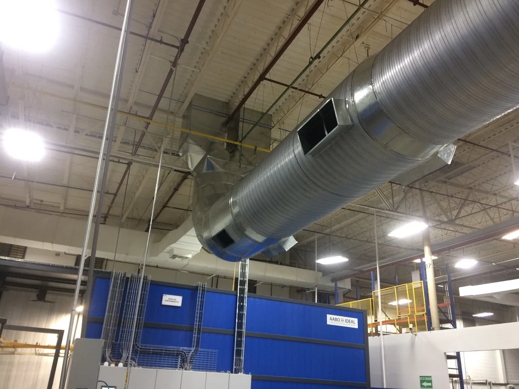 Ducto metálico de ventilación instalado sobre un área de producción industrial